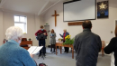 Peter leading the service with carols on his guitar